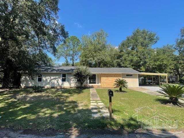 ranch-style home with a front yard and a carport