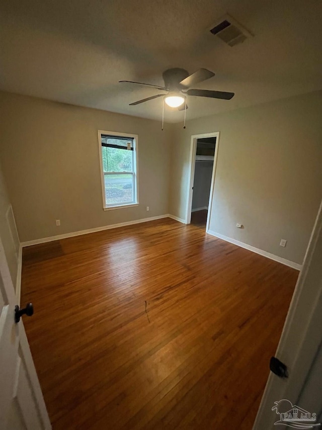 unfurnished room with wood-type flooring and ceiling fan