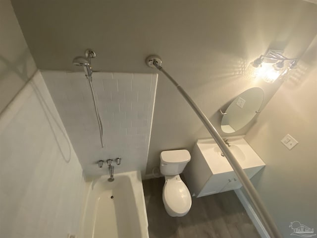 full bathroom with vanity, washtub / shower combination, wood-type flooring, and toilet