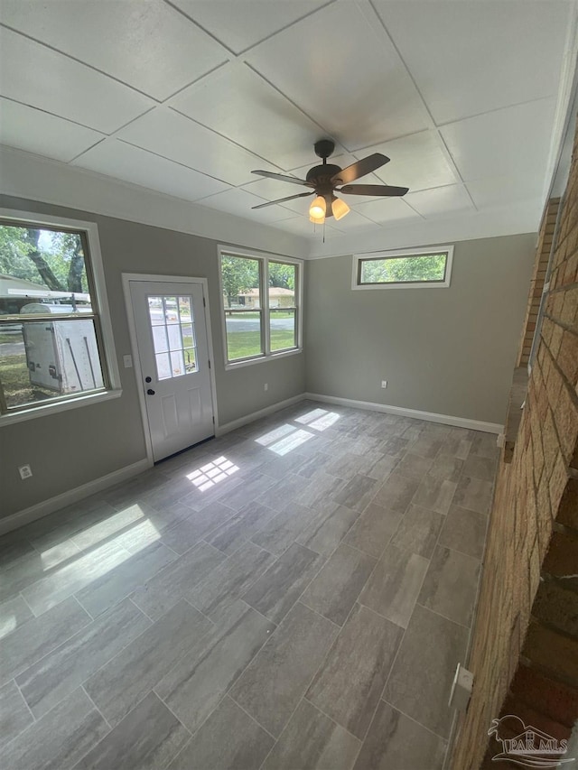 unfurnished room featuring a paneled ceiling and ceiling fan