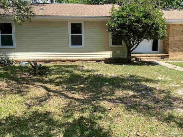 view of side of property with a lawn