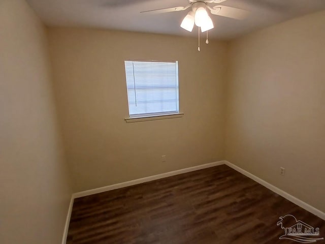 empty room with dark hardwood / wood-style flooring and ceiling fan