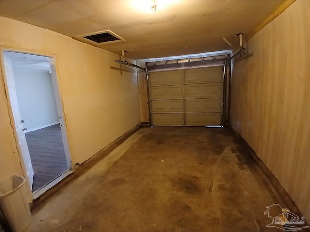 garage featuring wooden walls