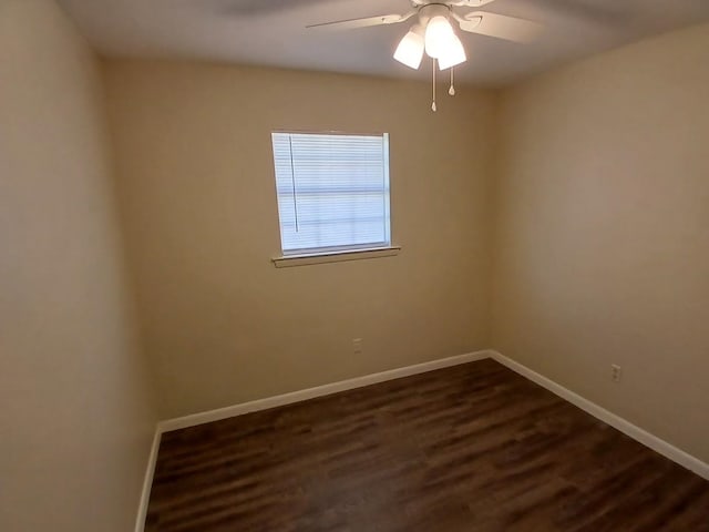 spare room with ceiling fan and dark hardwood / wood-style flooring