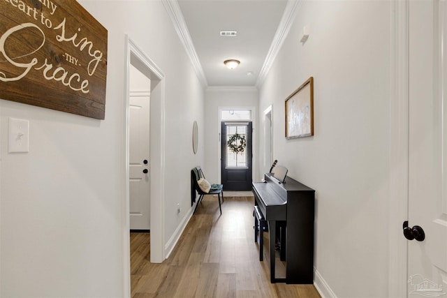 interior space with crown molding and light hardwood / wood-style flooring