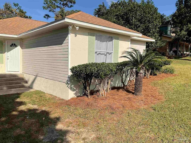 view of property exterior with a lawn