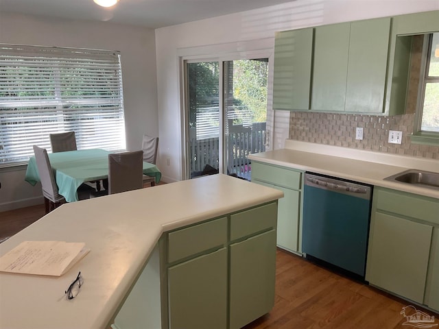 kitchen with dishwasher, dark hardwood / wood-style floors, plenty of natural light, and green cabinets