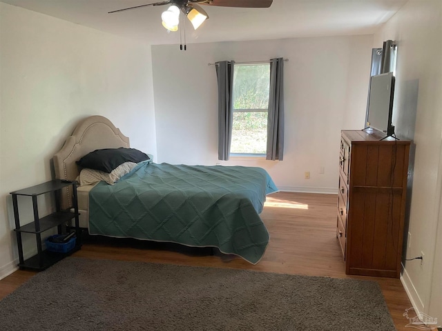 bedroom featuring ceiling fan and dark hardwood / wood-style floors