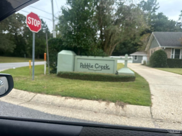 community / neighborhood sign with a lawn