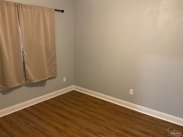 empty room with dark wood-type flooring