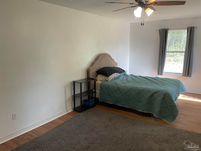 bedroom featuring ceiling fan and dark hardwood / wood-style flooring