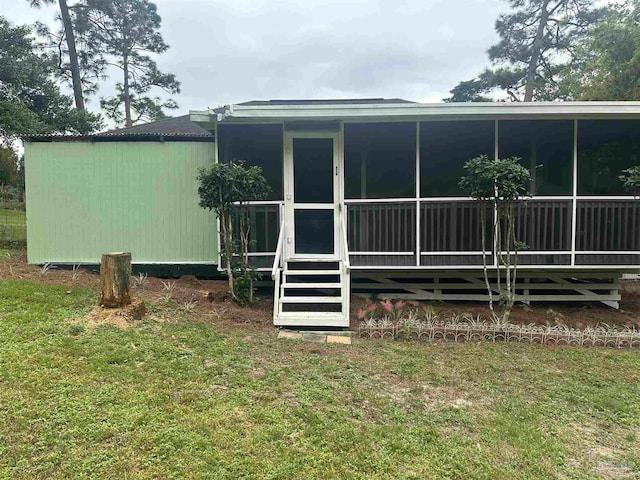 back of house with a lawn
