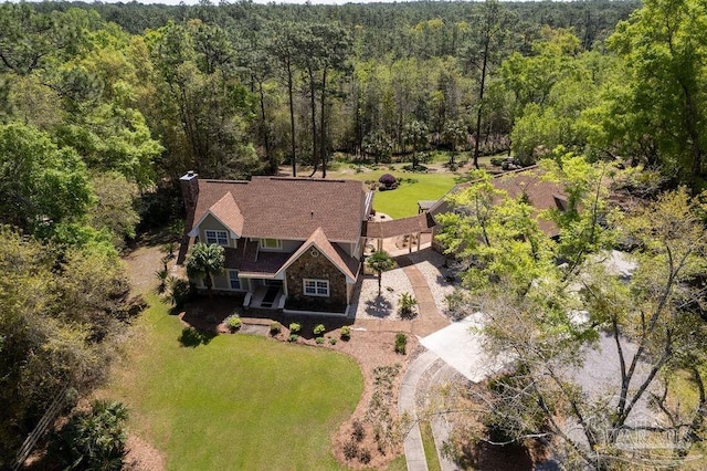 birds eye view of property with a wooded view