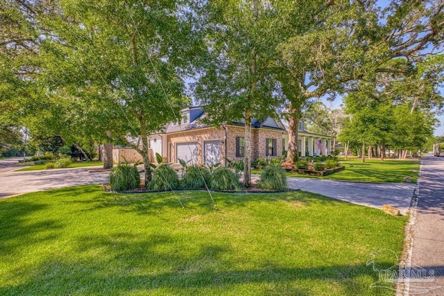 view of front facade with driveway, brick siding, a garage, and a front yard