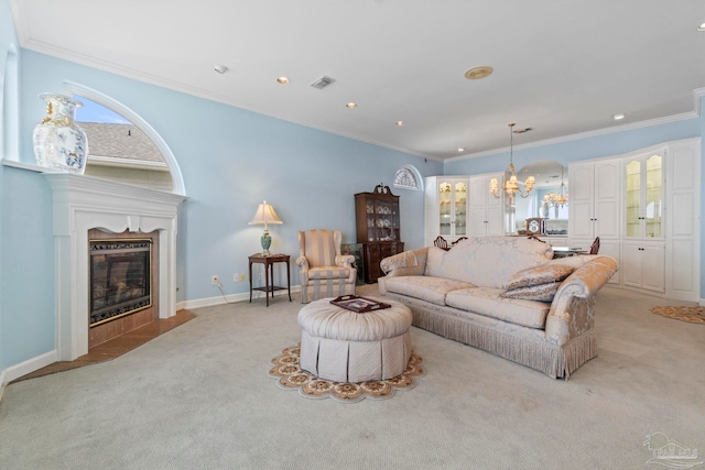 4757 Chinquapin Dr, Gulf Breeze, FL 32563 - living area with light colored carpet, a chandelier, crown molding, recessed lighting, and a fireplace with flush hearth