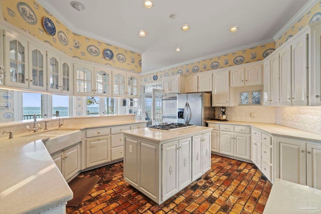 4757 Chinquapin Dr, Gulf Breeze, FL 32563 - kitchen with appliances with stainless steel finishes, brick flooring, ornamental molding, glass insert cabinets, and recessed lighting