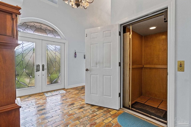 4757 Chinquapin Dr, Gulf Breeze, FL 32563 - entryway featuring elevator, french doors, healthy amount of natural light, a chandelier, and a high ceiling