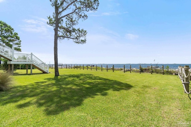4757 Chinquapin Dr, Gulf Breeze, FL 32563 - view of grassy yard with stairs and a water view