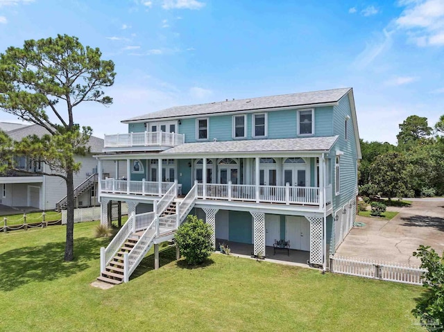 4757 Chinquapin Dr, Gulf Breeze, FL 32563 - rear view of house featuring stairway, driveway, an attached garage, covered porch, and a shingled roof