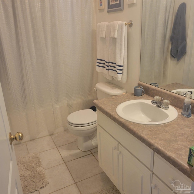 bathroom featuring vanity, tile patterned flooring, and toilet