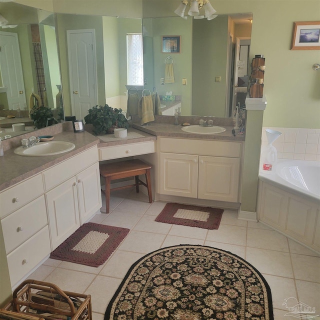 bathroom with tile patterned floors, vanity, and a tub