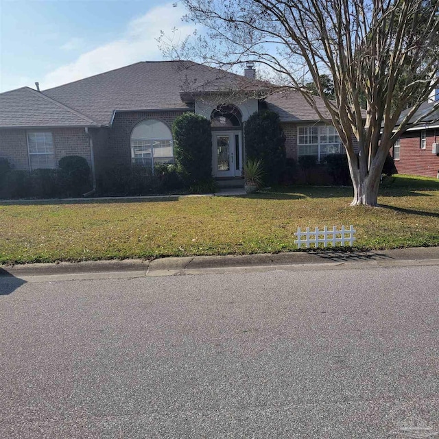 ranch-style home featuring a front yard