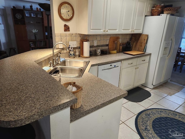 kitchen with sink, kitchen peninsula, white appliances, and white cabinets