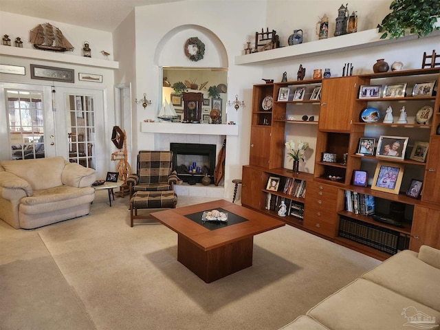 carpeted living room with a fireplace and french doors