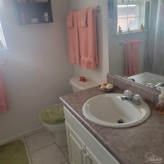 bathroom featuring toilet, tile patterned flooring, and vanity