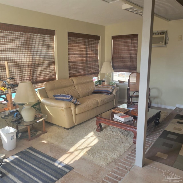 living room featuring a wall unit AC and light tile patterned floors