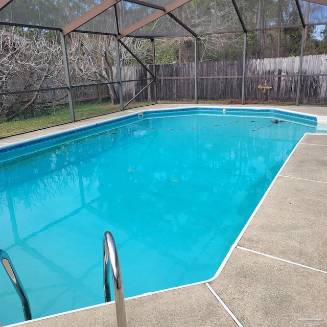 view of pool with glass enclosure