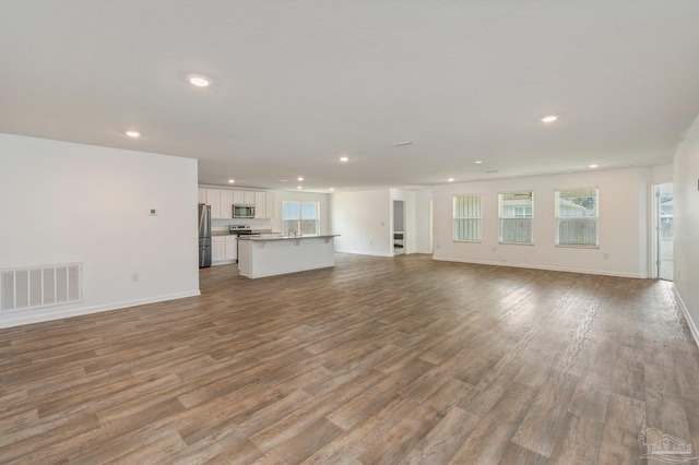 unfurnished living room featuring wood-type flooring