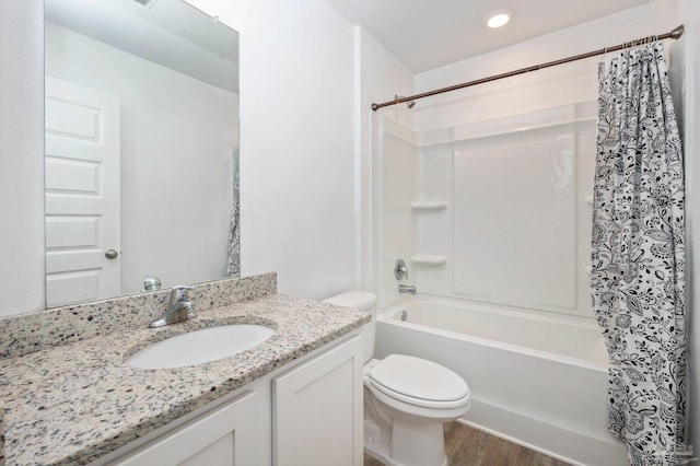 full bathroom featuring vanity, toilet, wood-type flooring, and shower / bath combo