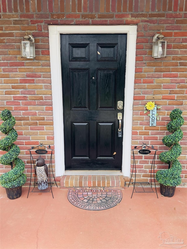 property entrance featuring brick siding