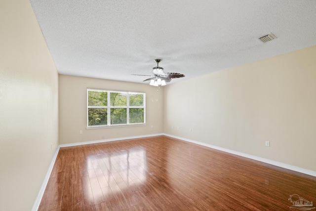 2121 Middleton Dr, Navarre, FL 32566 - spare room with visible vents, wood finished floors, baseboards, ceiling fan, and a textured ceiling