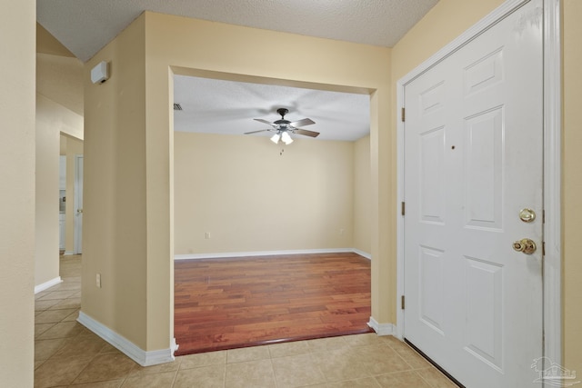 2121 Middleton Dr, Navarre, FL 32566 - entrance foyer featuring light tile patterned floors, baseboards, a ceiling fan, and a textured ceiling