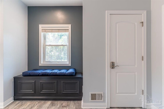 interior space featuring visible vents, baseboards, and wood finished floors