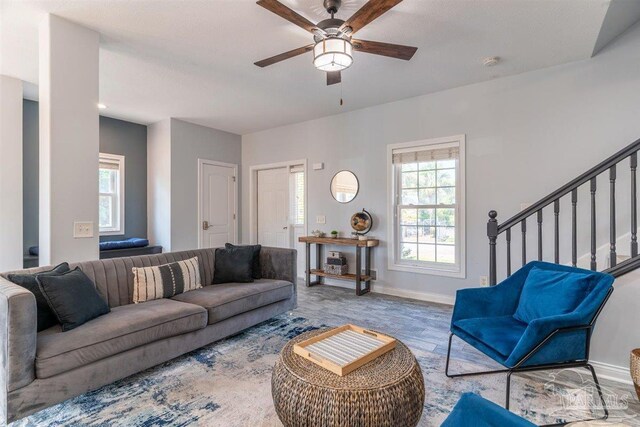 living room featuring hardwood / wood-style floors and ceiling fan