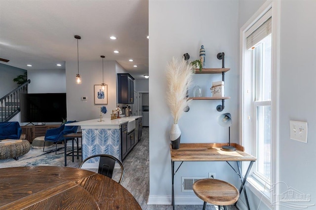 dining space with dark wood-type flooring, visible vents, and recessed lighting