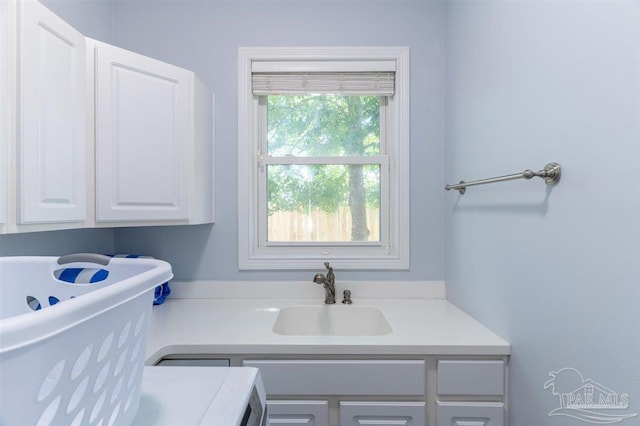 washroom featuring a sink and cabinet space