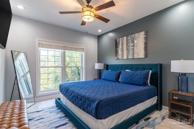 bedroom featuring ceiling fan and light wood-type flooring