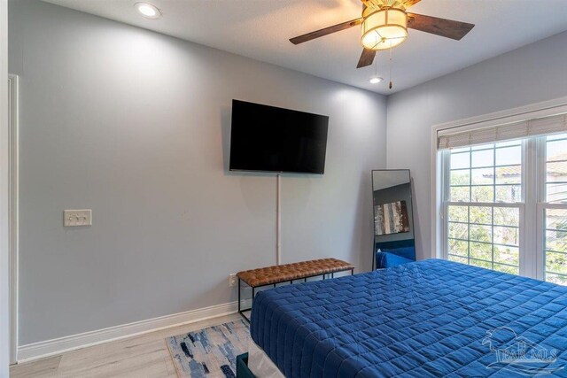 bedroom featuring hardwood / wood-style flooring and ceiling fan