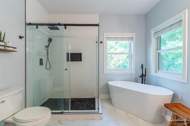 full bathroom featuring a freestanding bath, marble finish floor, a stall shower, and toilet