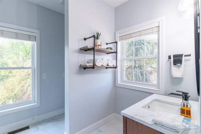 bathroom featuring a healthy amount of sunlight, vanity, and tile patterned floors