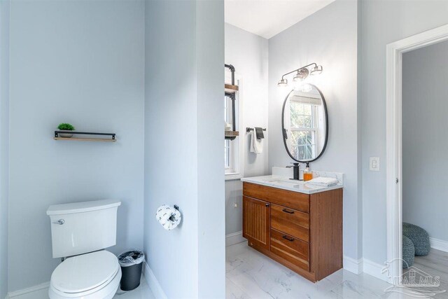 bathroom with tile patterned flooring, toilet, and vanity