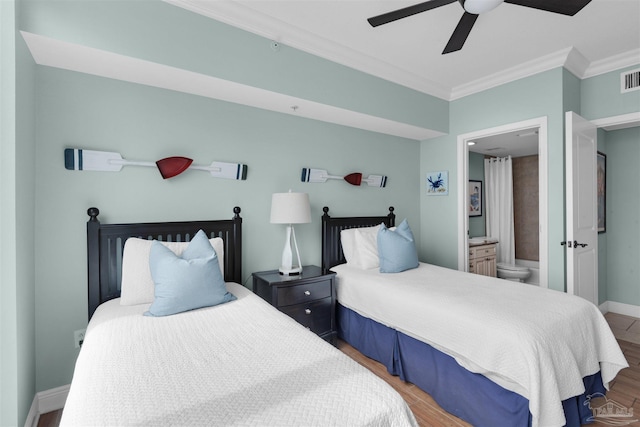 bedroom with wood-type flooring, ensuite bathroom, ceiling fan, and crown molding