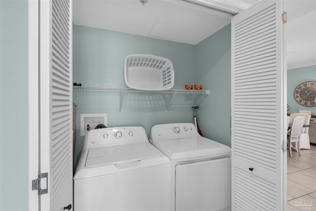 laundry room with light tile patterned flooring and washing machine and clothes dryer