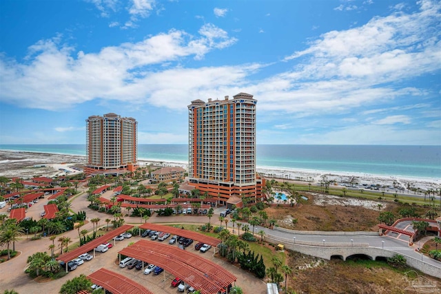 birds eye view of property with a water view and a beach view