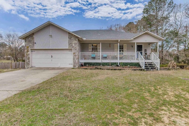 ranch-style house featuring a garage, covered porch, and a front yard