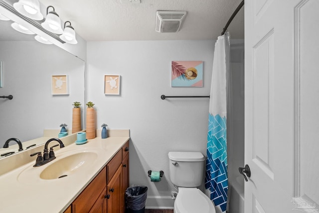 full bathroom with visible vents, toilet, curtained shower, a textured ceiling, and vanity